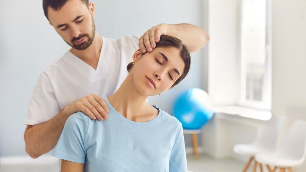 A physiotherapist treating a patient with a neck pain